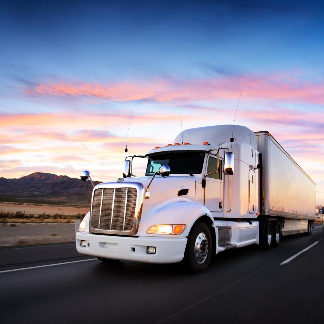 Truck and highway at sunset – transportation background